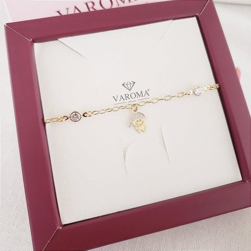 Pulseira com um pingnete de menino ou menina e dois pontos de luz banhado em ouro 18k